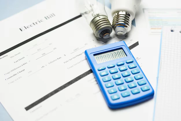 Electric bill with calculator and light bulbs showing rising energy charges homeowners face when learning how to lower electric bill in summer DFW