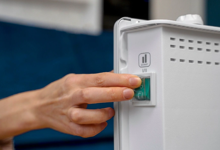 Homeowner switching on a tankless water heater, showing the on demand operation that makes these units popular with DFW households