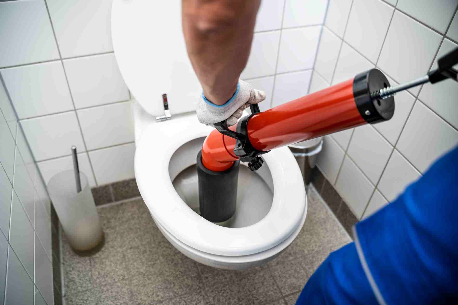 Reliable Toilet Installation and Repair Services in Texas Image of a plumber providing toilet blockage assistance and WC cleaning, featuring Christmas Air Conditioning and Plumbing, and highlighting reliable toilet installation and repair services in Texas.