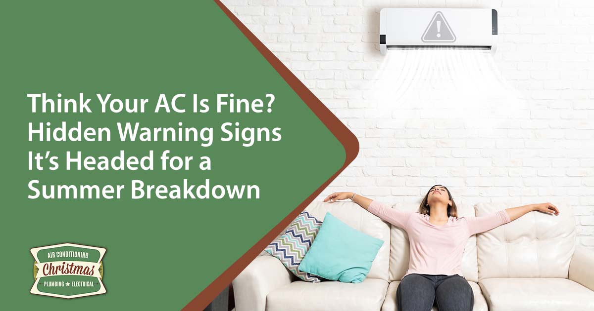 Image of a Latin young woman relaxing under a mini split AC on a sofa in the living room, featuring Christmas Air Conditioning and Plumbing and highlighting hidden warning signs your AC may be headed for a summer breakdown.