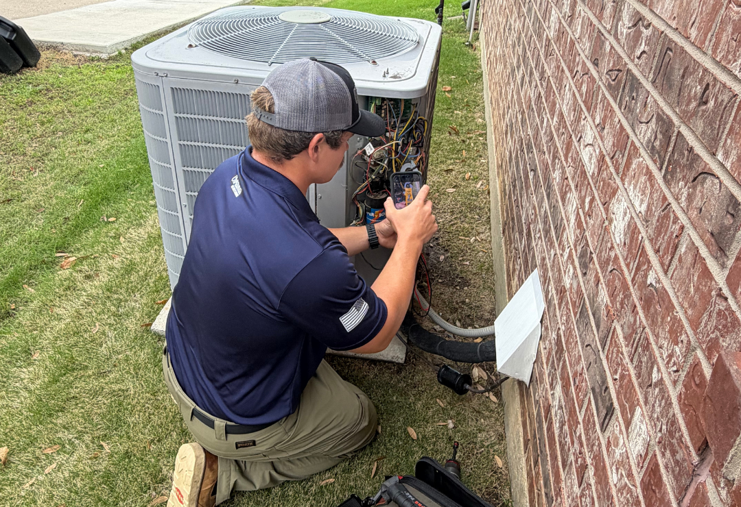 HVAC Maintenance - man adjusting the pressure on an HVAC system