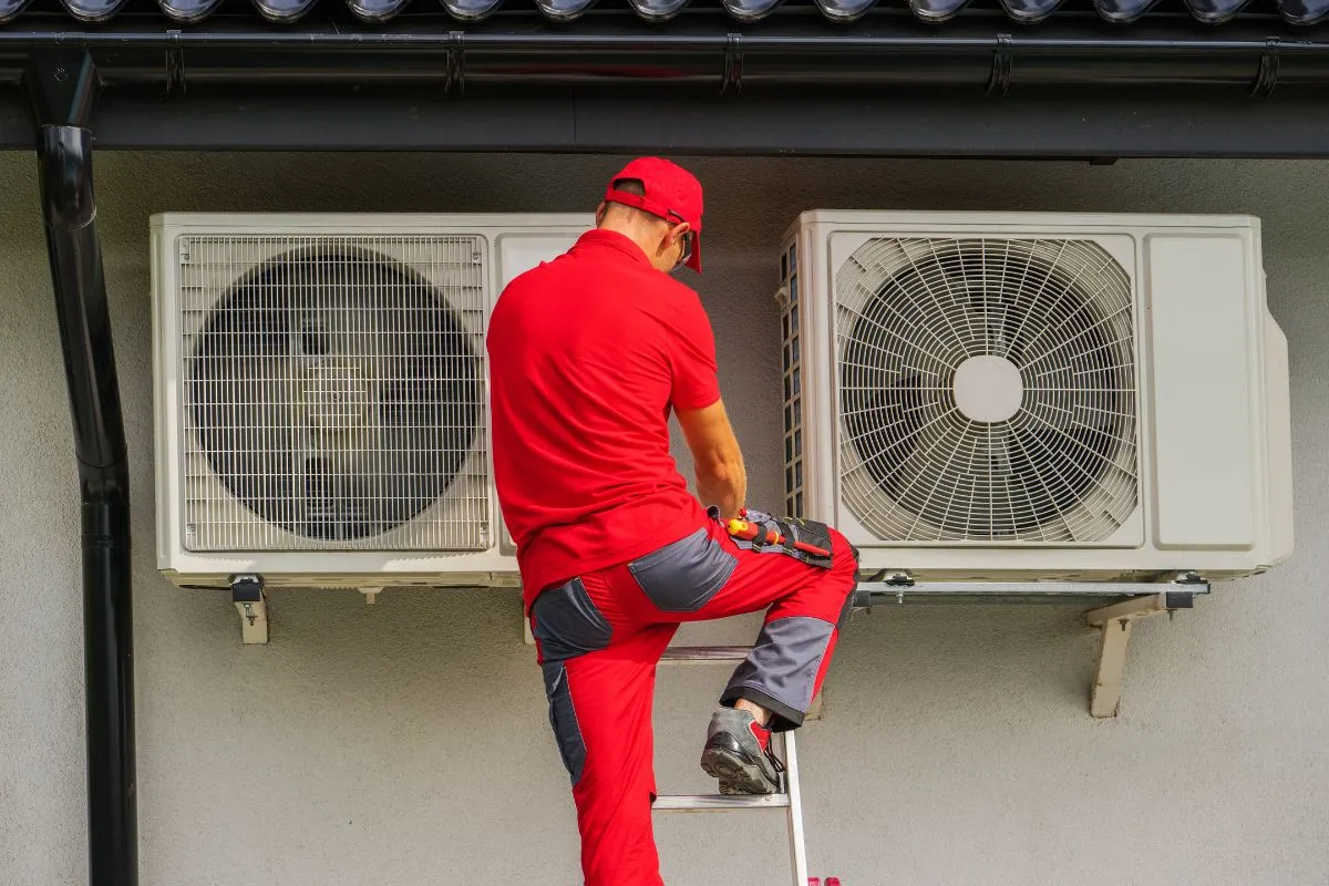 Best time to replace AC in Texas with a technician servicing two outdoor AC condensers