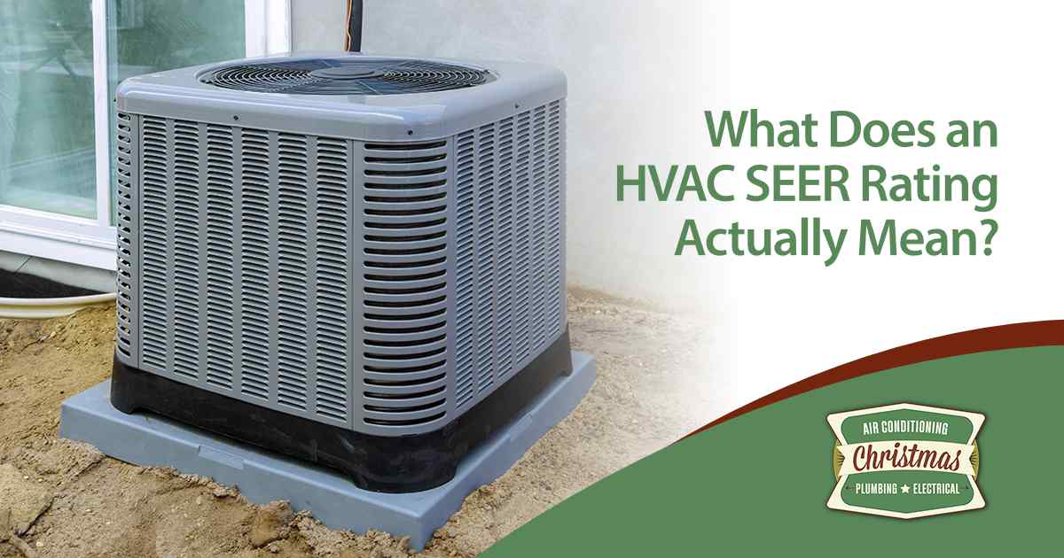 Outdoor HVAC unit beside building wall with text about SEER rating efficiency.