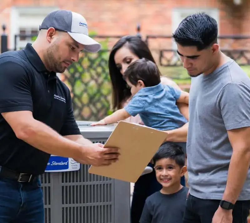 Image of a man explaining issues with a heat pump, featuring Air Conditioning Christmas and Heating. The image highlights their residential heating service and repair expertise, aligning with the page's focus on quality HVAC solutions.